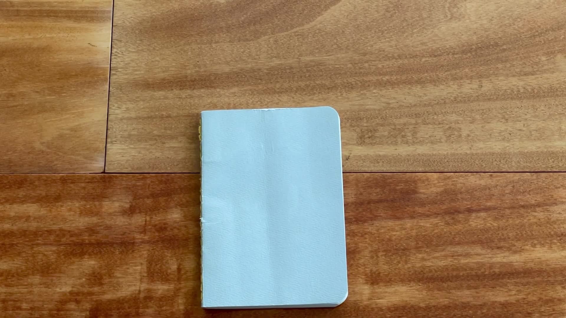 Baron Fig Apprentice pocket notebook closed on a wooden desk