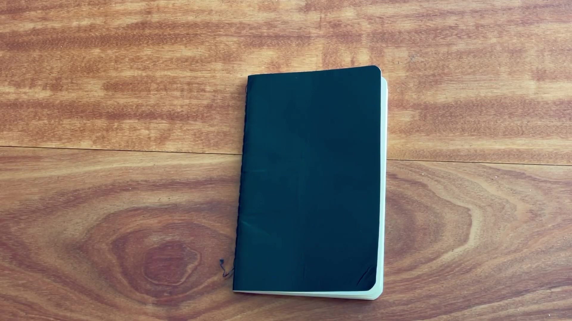 Daler Rowney pocket sketchbook closed on a wooden desk
