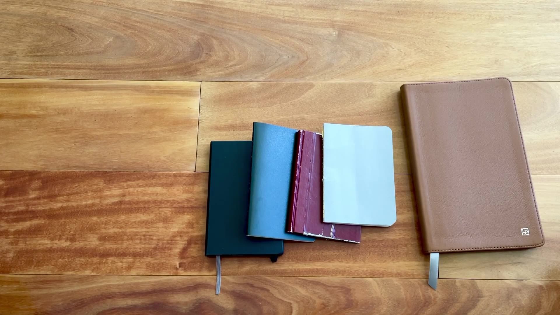 How I Got Back Into Journaling 1 Pocket notebooks and leather journal laid out for getting back into journaling