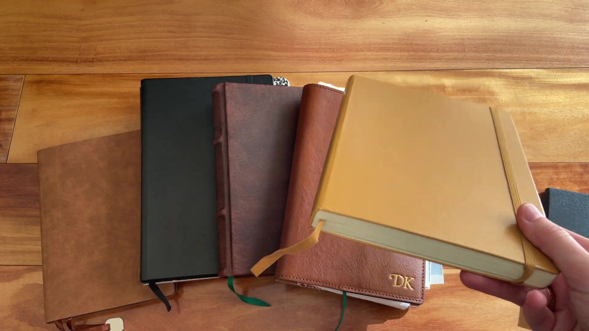How to Start Journaling: Beginner’s Guide 4 Several journal and notebook options compared on a wooden desk