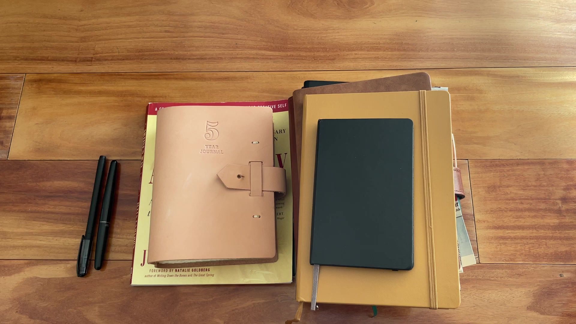 How to Start Journaling: Beginner’s Guide 2 A simple beginner journaling setup with notebooks, pens, and a quiet desk