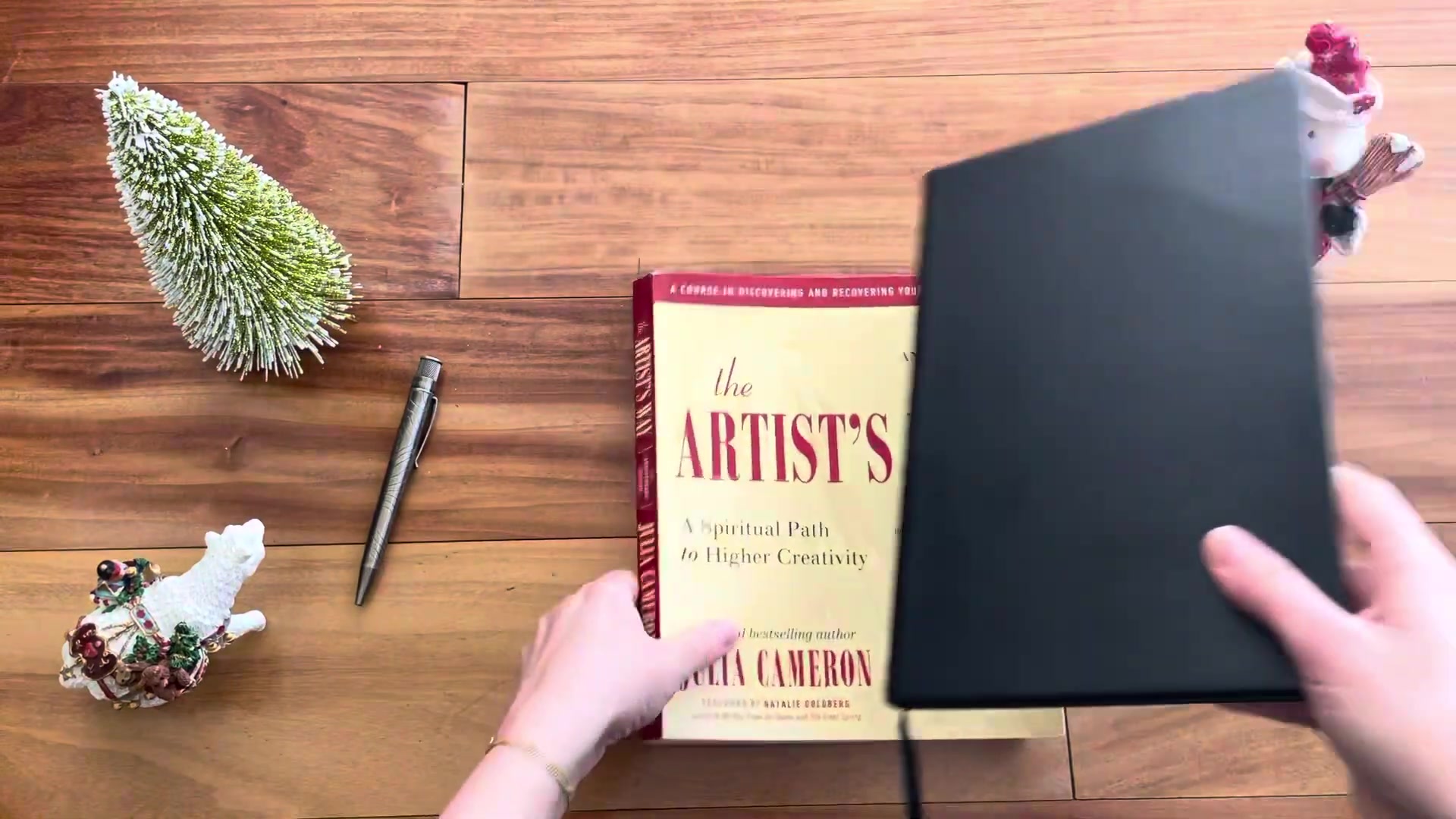 The Artist’s Way book paired with a notebook for journaling