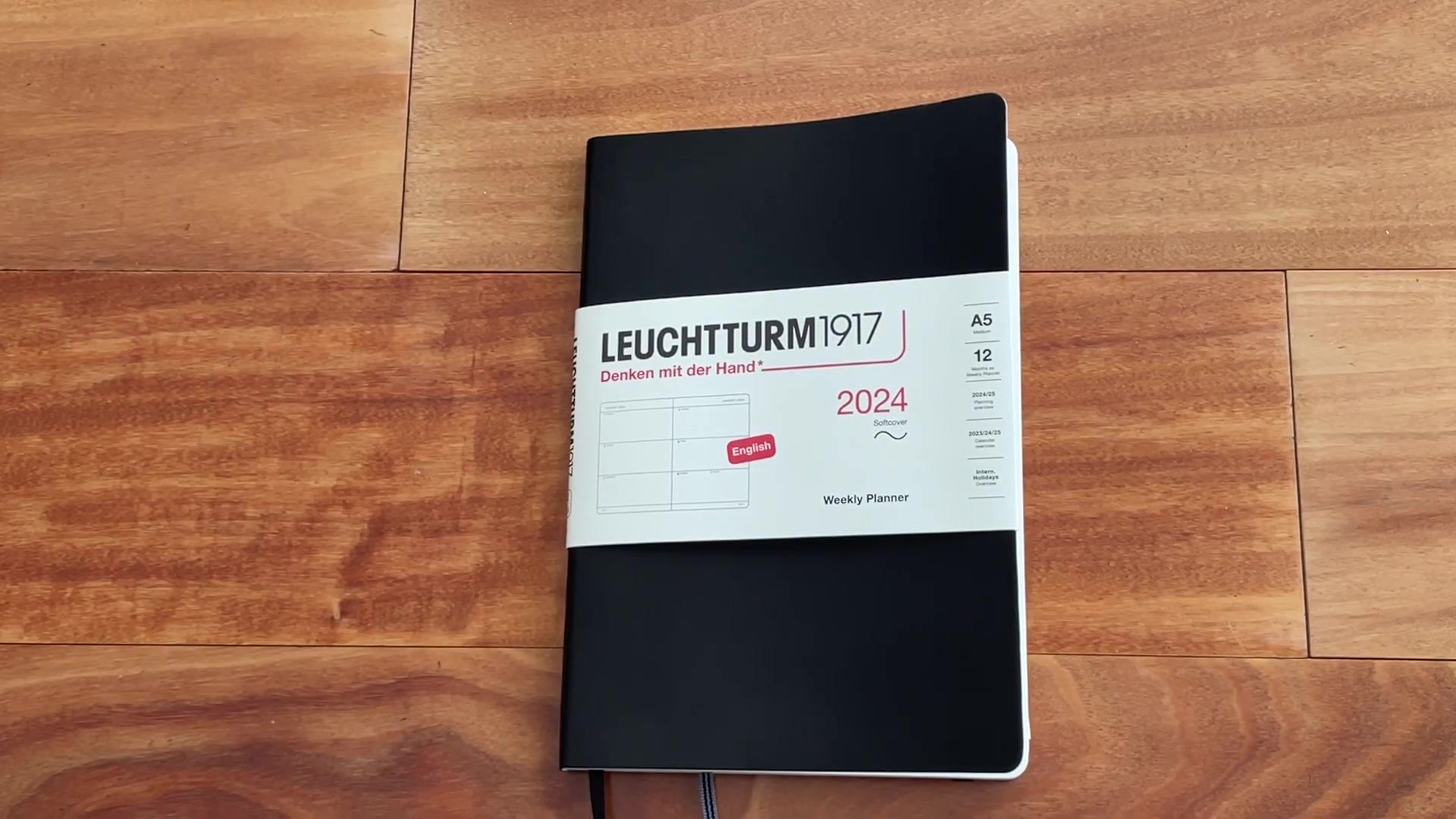 Leuchtturm1917 Weekly Planner Horizontal Review 1 Leuchtturm1917 Weekly Planner Horizontal with 2024 sleeve on wooden desk
