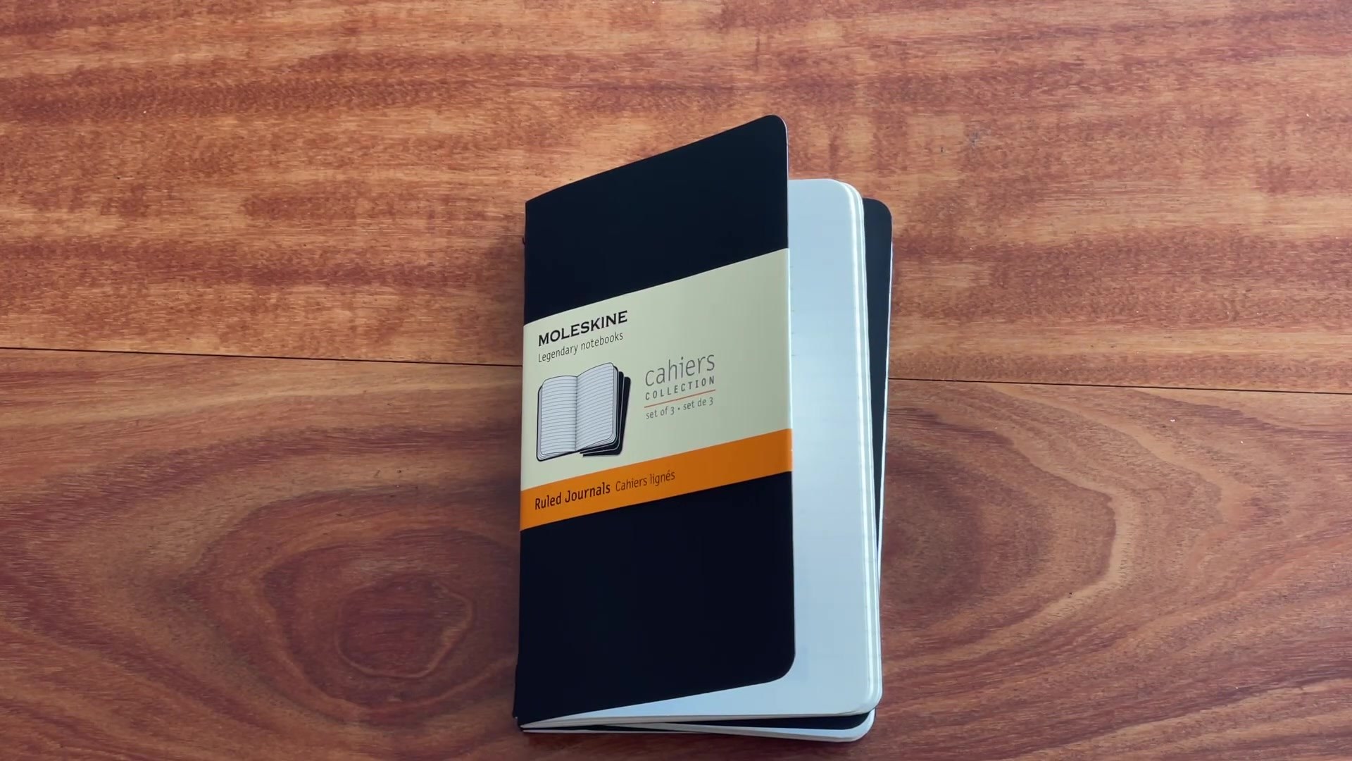 Moleskine Cahier pocket notebook pack shown on a wooden desk