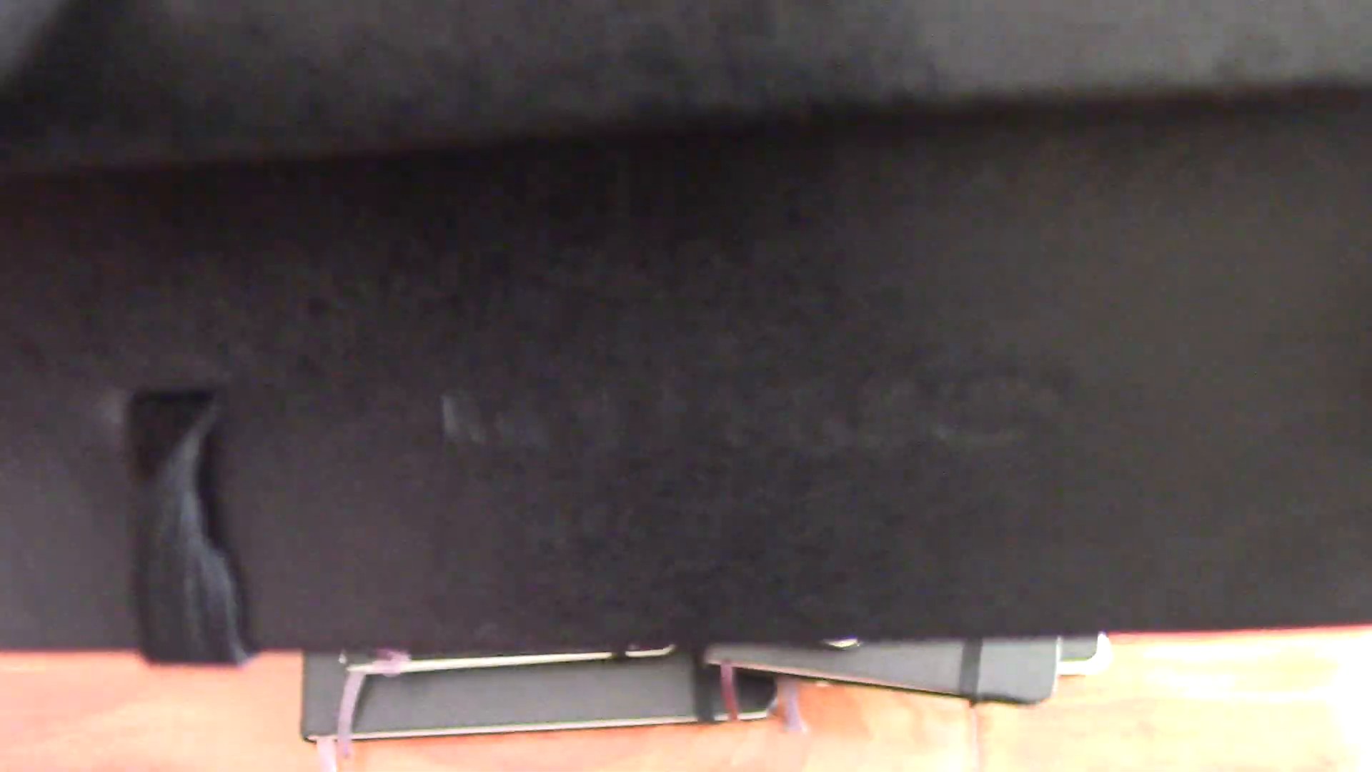 Close-up of the embossed Moleskine logo on a black notebook cover