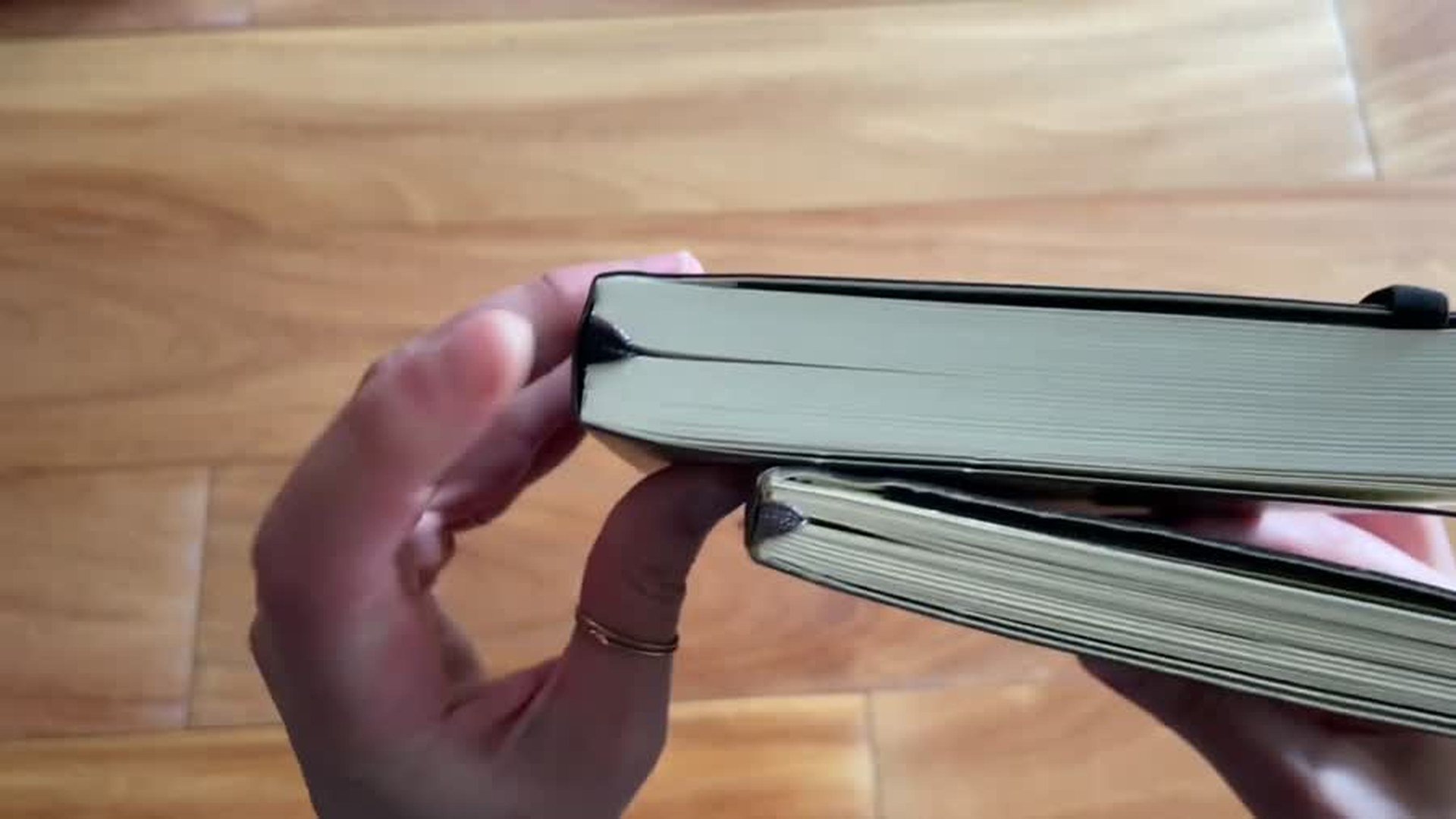 Side view comparing Moleskine notebook page block thickness and cover flexibility