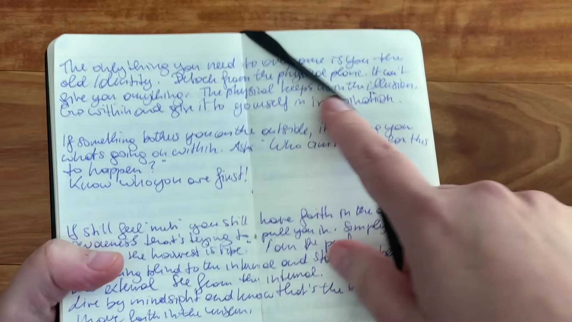 Handwritten notes extending across an open Writersblok double-page spread